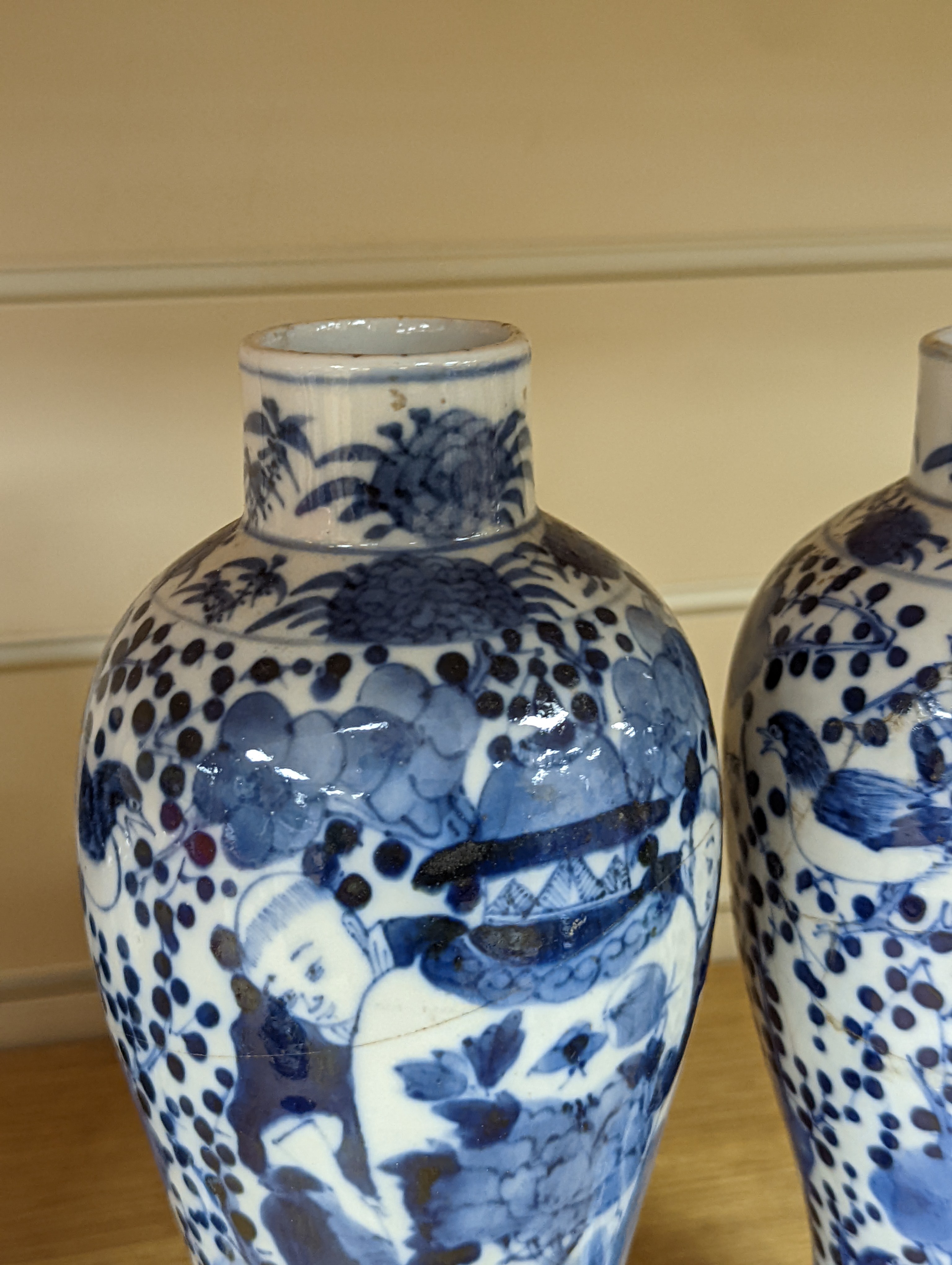 A pair of 19th century Chinese blue and white vases, a prunus vase and cover and a similar jar (4), pair of vases 24 cms high.